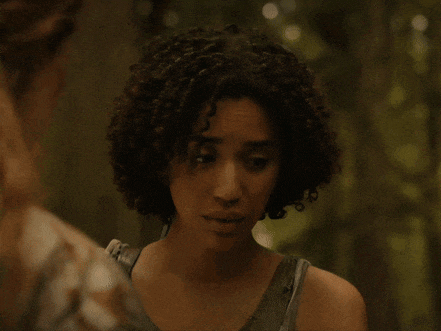 a woman with her eyes closed looks at another woman