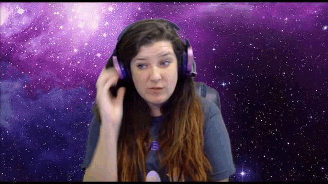 a woman wearing headphones with a galaxy background