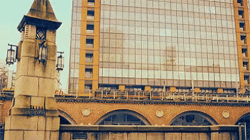 a large building with a clock tower in front of it that says ' tokyo ' on it