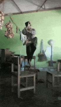 a person sitting on a chair with a green wall behind them