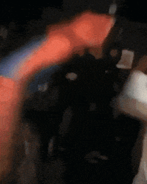 a blurry image of a person in a red and blue costume