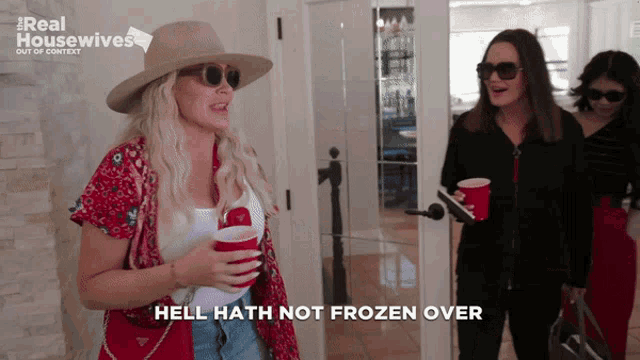 a woman says hell hath not frozen over while holding two red cups