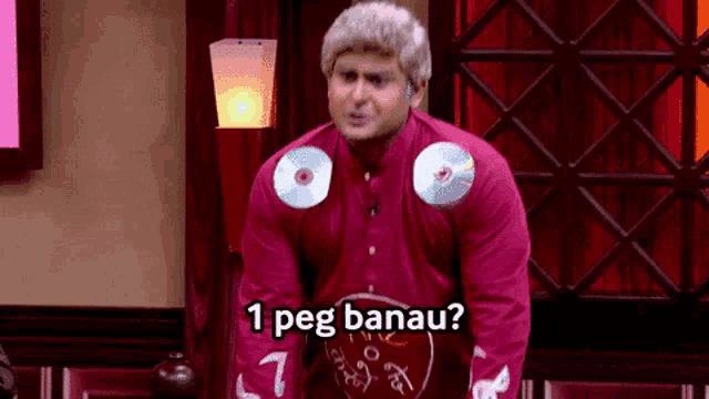 a man in a red shirt with cds on his shoulder says 1 peg banau ?