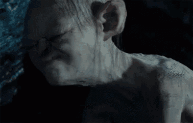 a close up of a gollum from the lord of the rings with his mouth open and a surprised look on his face .