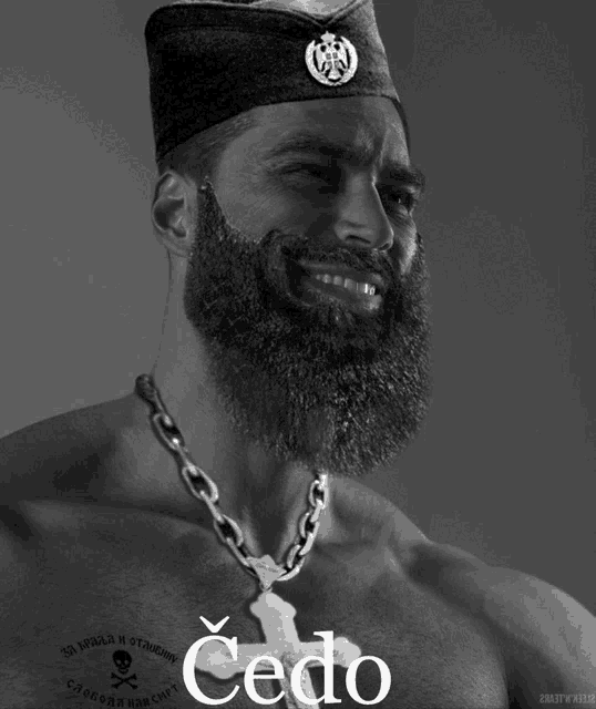 a man with a beard is wearing a chain around his neck and has the word cedo on his chest