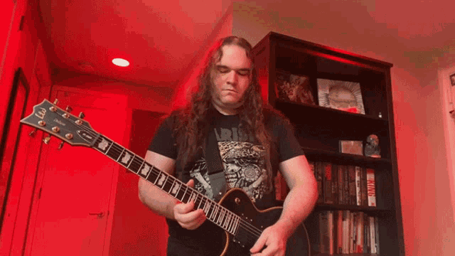 a man with long hair is playing a guitar with a yamaha logo on it