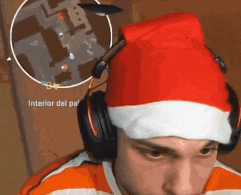 a man wearing headphones and a santa hat is playing a game