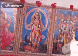 a painting of a deity is hanging on a wall in a room .