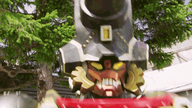 a robot with a large gun on its head is standing in front of a tree