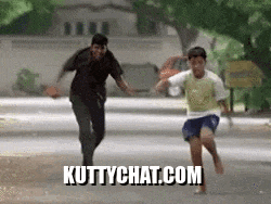 a man and a boy are running down a street with the website kuttychat.com written on the bottom .