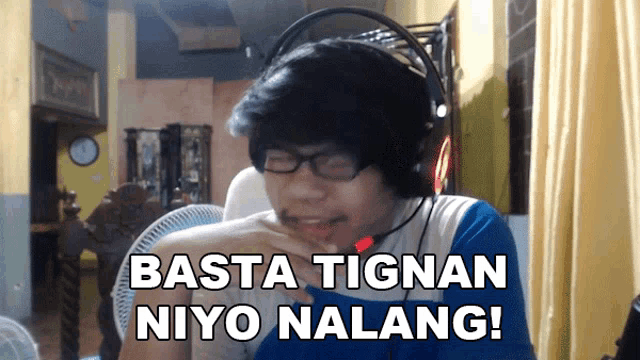 a man wearing headphones says basta tignan niya nalang