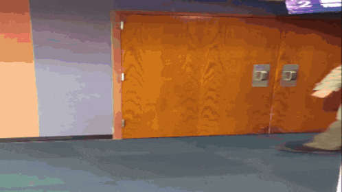 a person is walking in a hallway with a sign that says 2