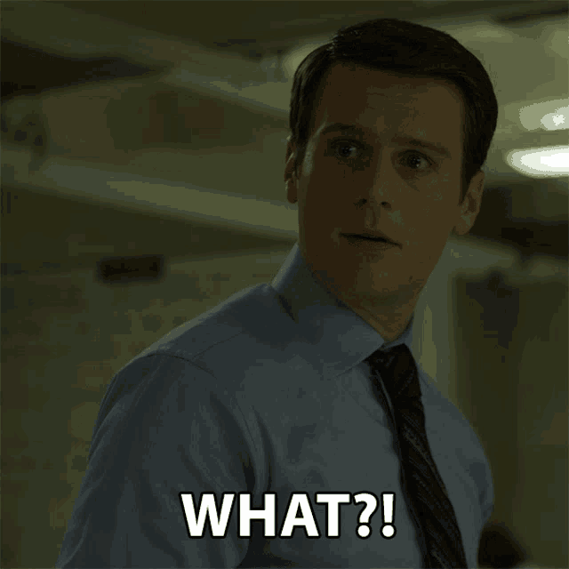 a man in a blue shirt and tie is asking the question what