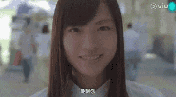 a close up of a woman 's face with a blurred background .