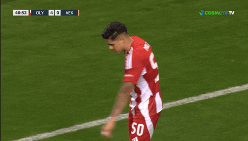 a soccer player with the number 50 on his shorts is celebrating a goal