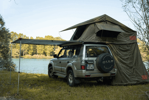 a toyota with a tent on top of it and a license plate that says dj-972-hl