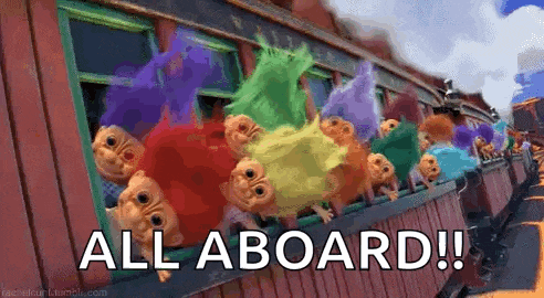 a bunch of trolls are sitting on a train with the words `` all aboard '' written on it .