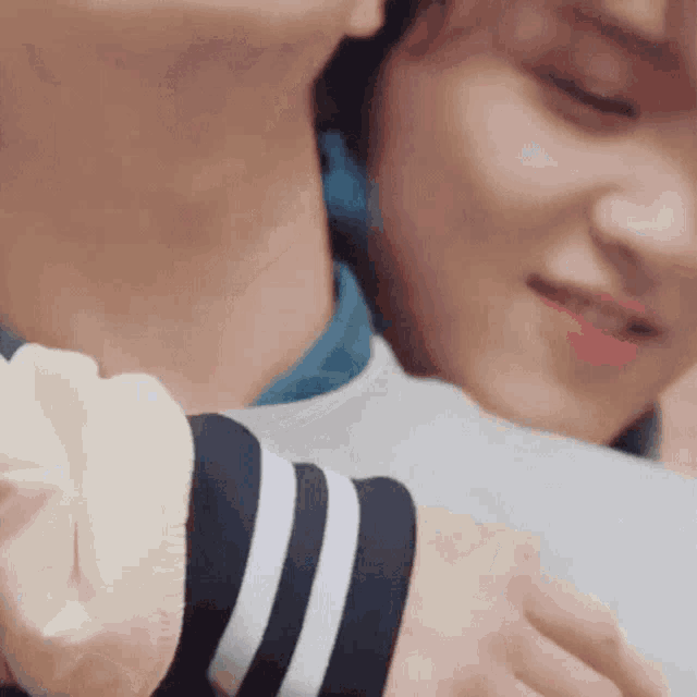 a close up of a person holding another person 's arm .