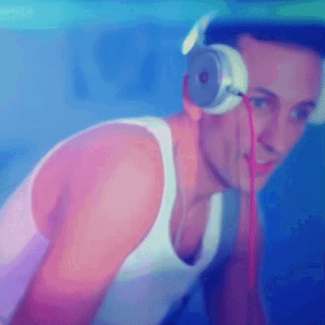 a man wearing headphones and a tank top