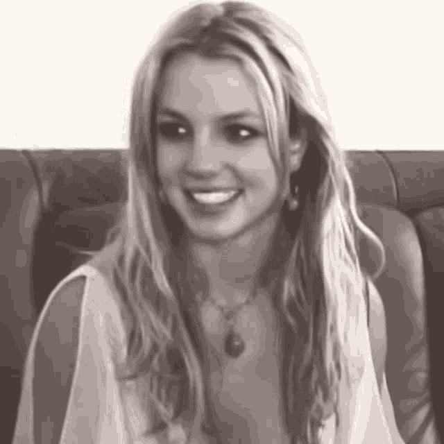 a black and white photo of britney spears sitting on a couch