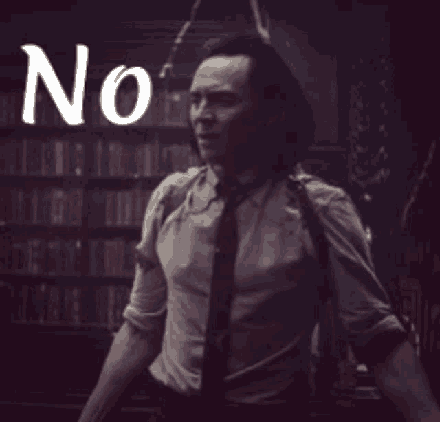 a man in a suit and tie is standing in front of a bookshelf with the word no written above him