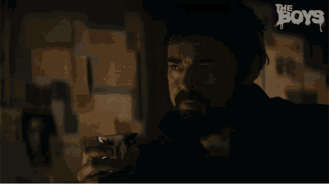 a man in a dark room with the word boys on the bottom