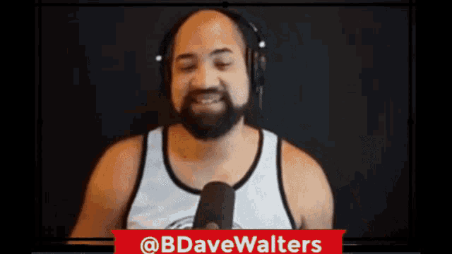 a man with a beard is wearing headphones and talking into a microphone with the hashtag @bbdavewalters