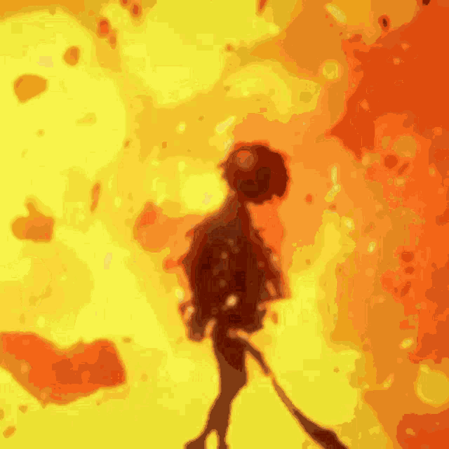 a silhouette of a person walking in front of a yellow and red background