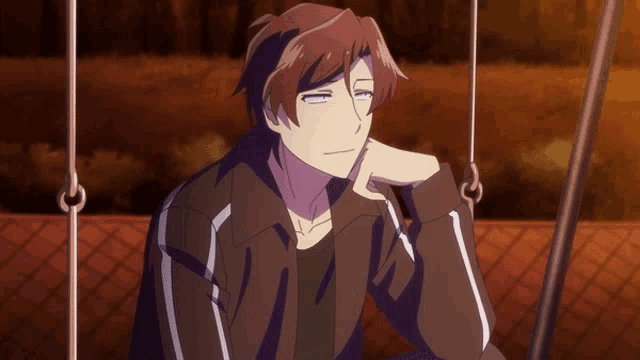 a man sitting on a swing with his hand on his face