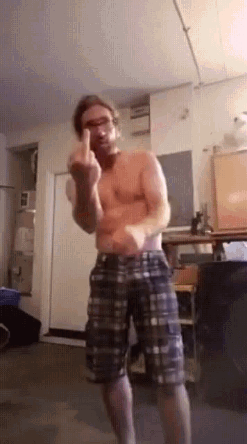 a shirtless man is giving the middle finger