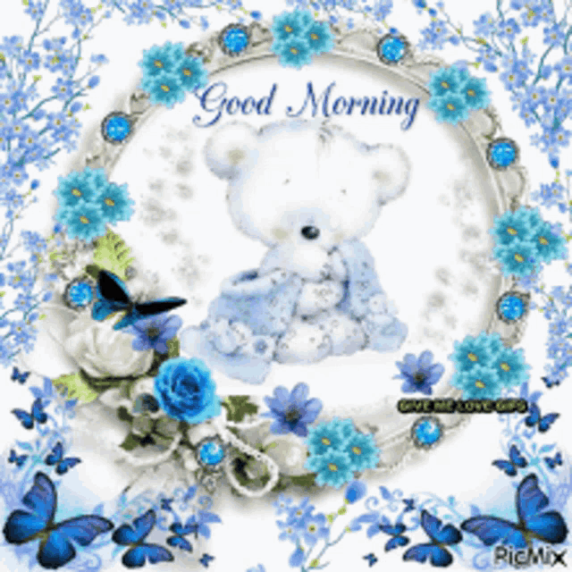 a picture of a teddy bear surrounded by blue flowers and butterflies