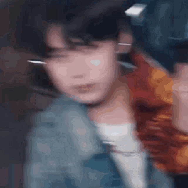 a blurry picture of a person 's face and neck