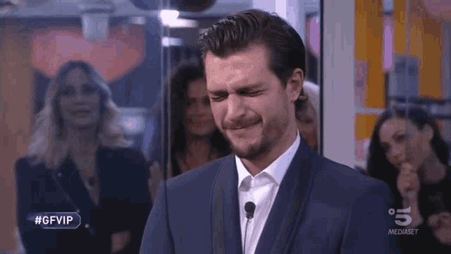 a man in a suit is crying on a tv show called #gfvip