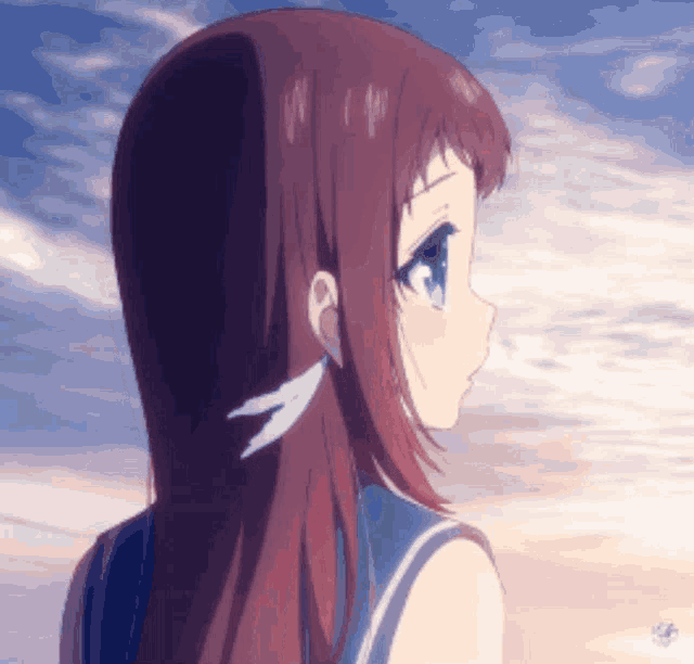 a girl with long red hair and blue eyes looks to the side