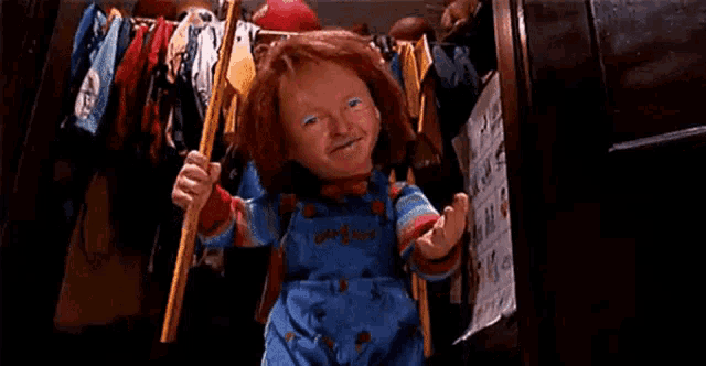 a child 's doll is holding a bat in a room .