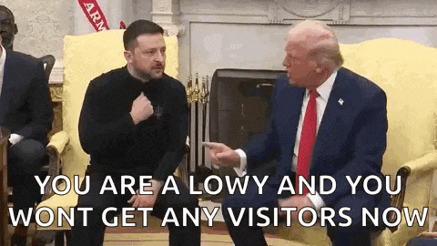 a man in a suit and tie is sitting next to a man in a black shirt and talking to donald trump .