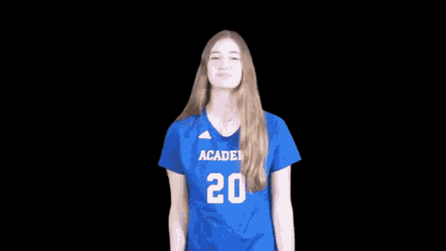 a girl wearing a blue shirt that says academy 20 on it