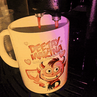 a mug that says deejay makina is being poured into a coffee machine