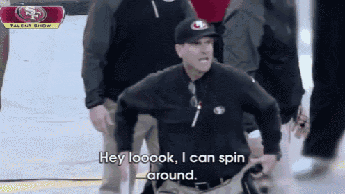 a man wearing a san francisco 49ers hat says hey loook i can spin around