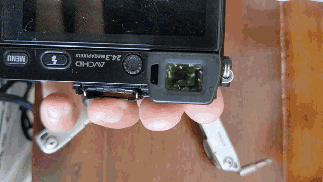 a person is holding a camera that says avchd 24.3 megapixels on it