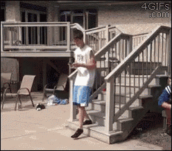 a man is standing on a set of stairs looking at his phone ..