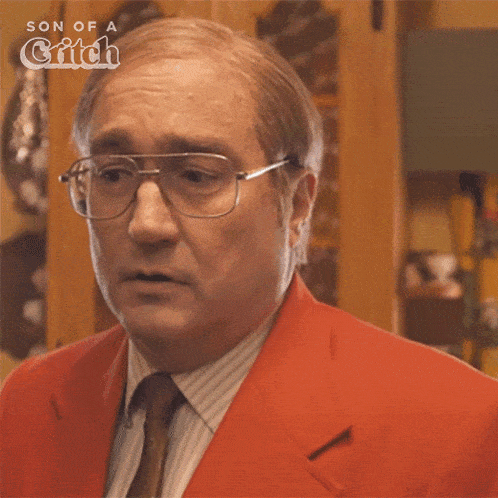 a man wearing glasses and a red suit says " i 'll call a cab "