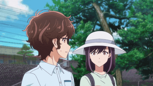 a boy and a girl are standing next to each other and looking at each other