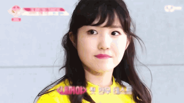 a girl in a yellow shirt with the word lintho on the bottom right
