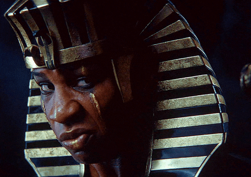 a close up of a man wearing a pharaoh 's crown