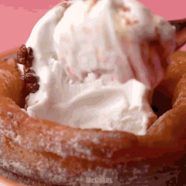 a scoop of ice cream is being poured into a donut with the words mr.cakes below it