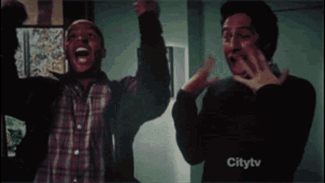 two men are screaming in front of a screen that says citytv on it