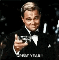 a man in a tuxedo is holding a glass of wine and making a toast .