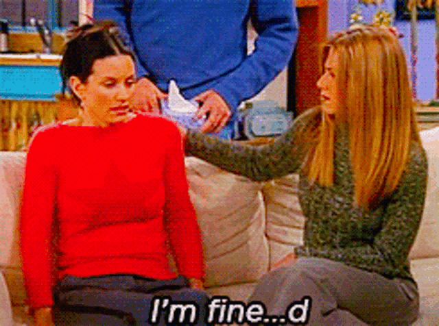 two women are sitting on a couch and one of them says i 'm fine
