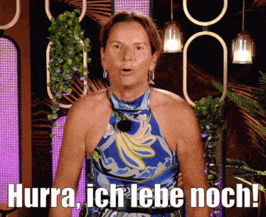 a woman in a blue dress says hurra ich lebe noch !